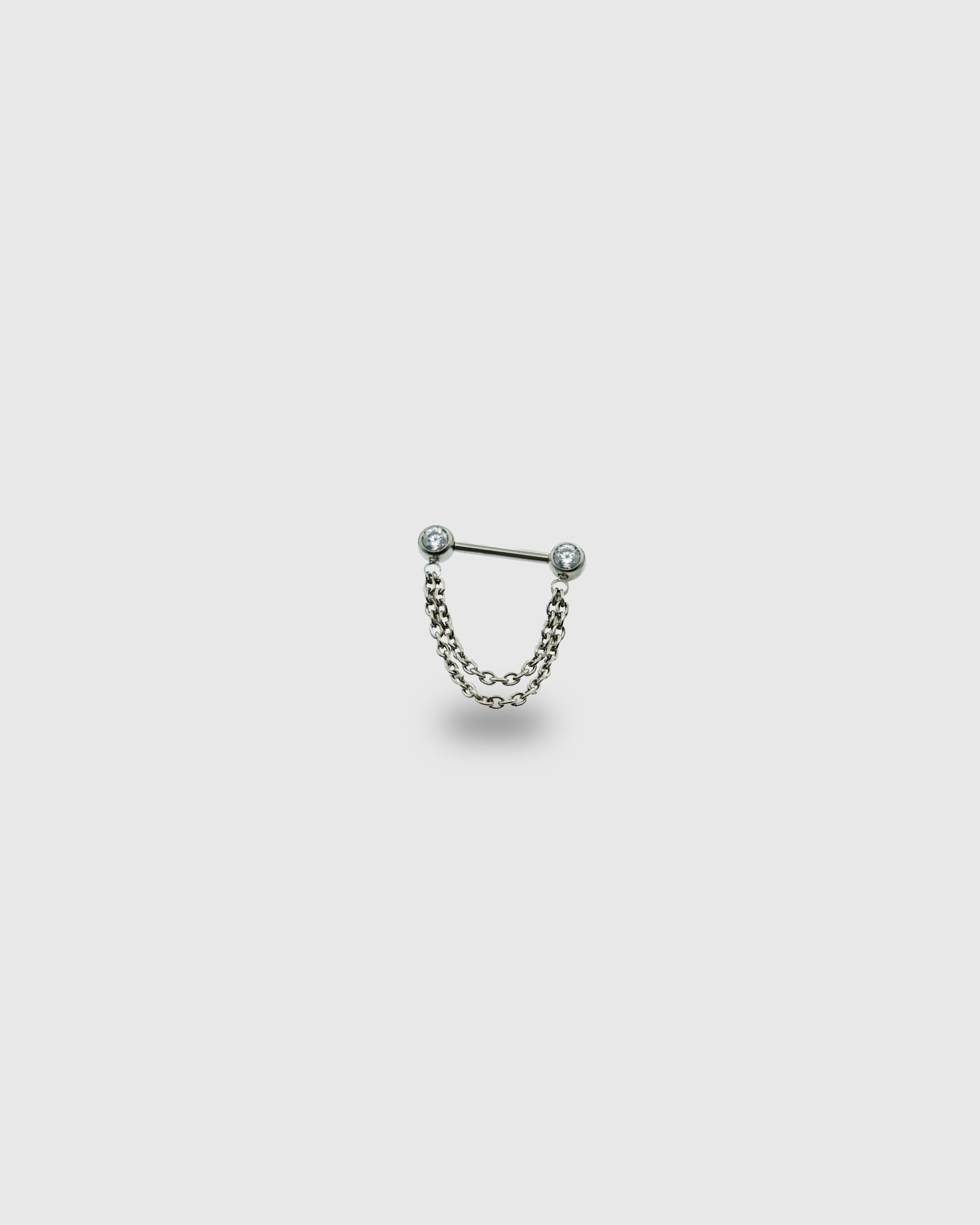 Piercing para pezón con circonitas y doble cadena